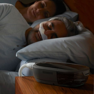 man sleeping with CPAP machine